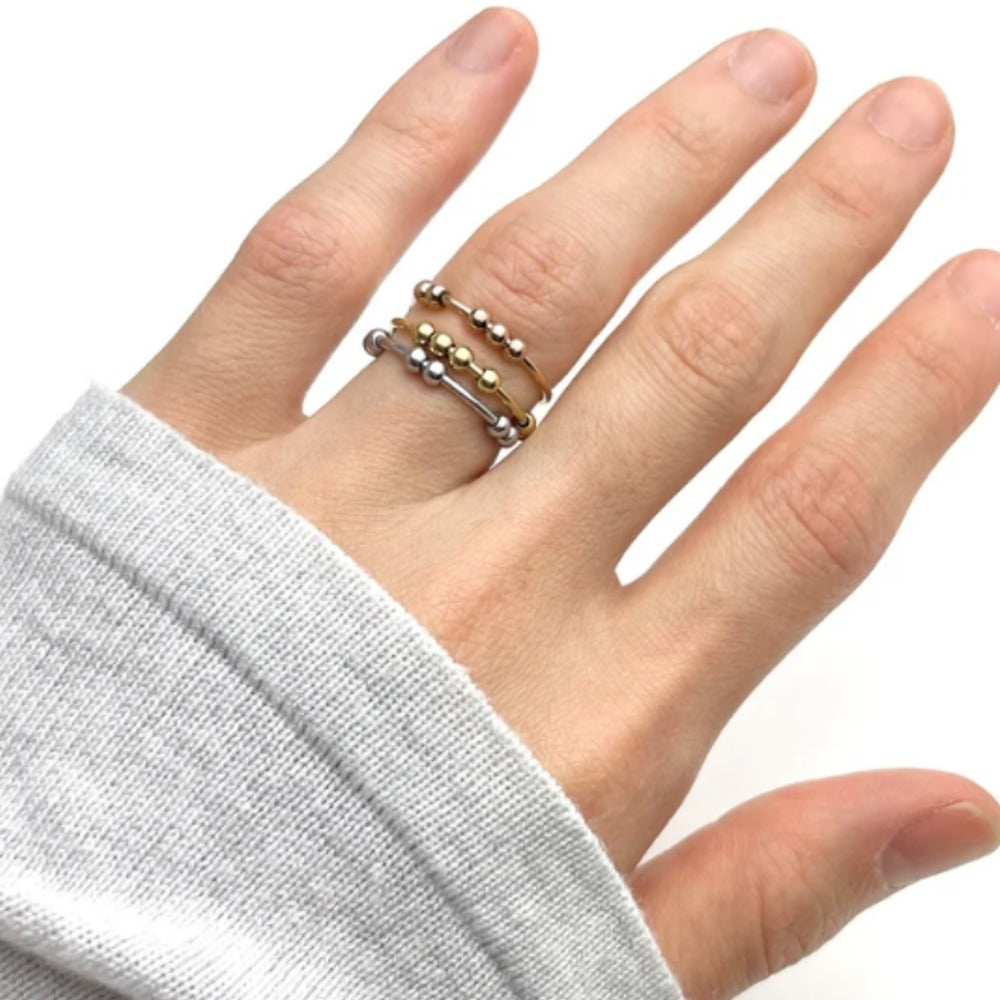 Fidget bead rings worn together on one finger