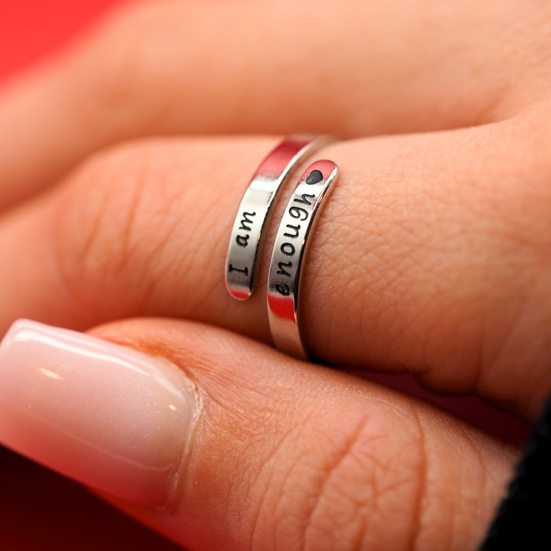 I Am Enough ring worn on a hand