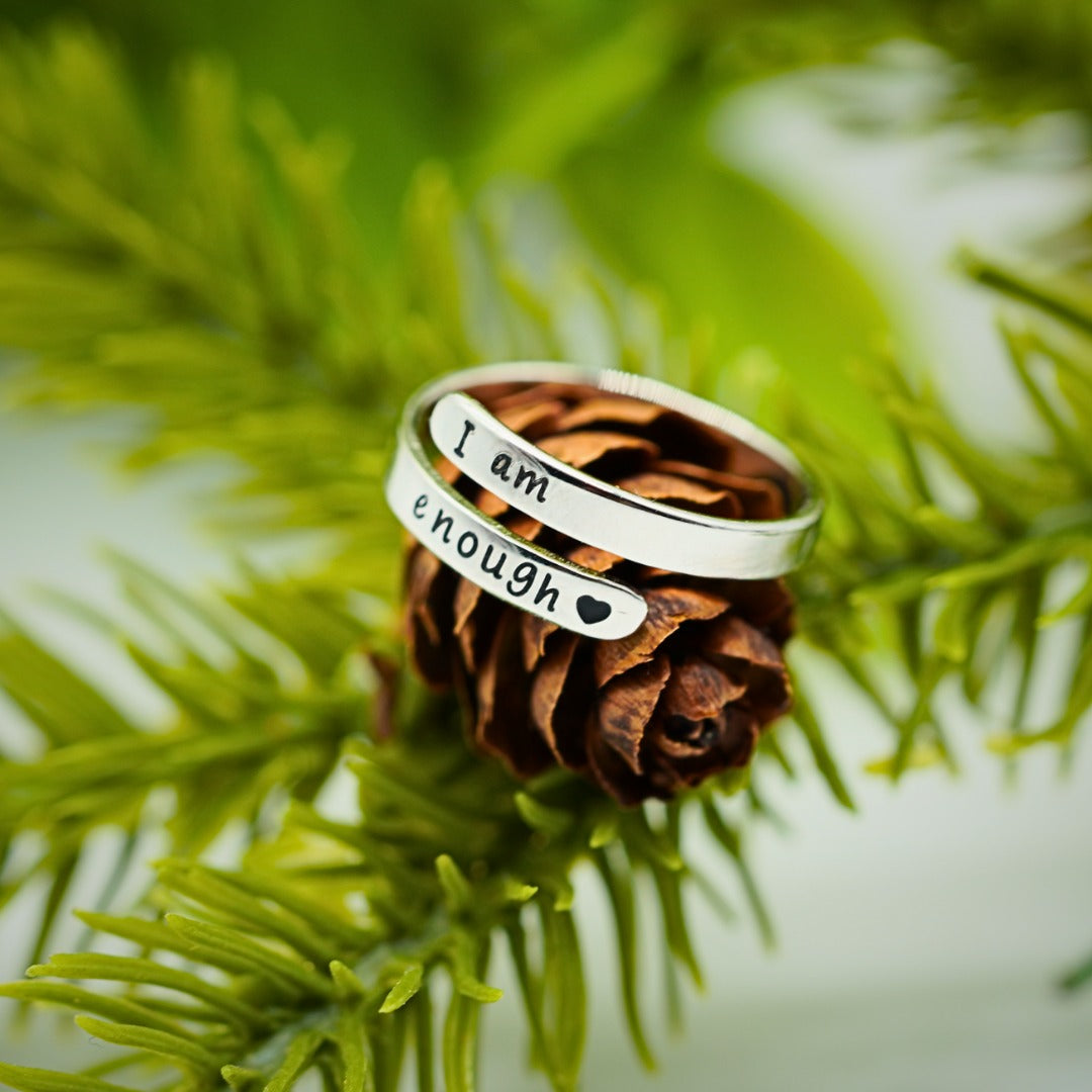 I Am Enough ring on a pinecone