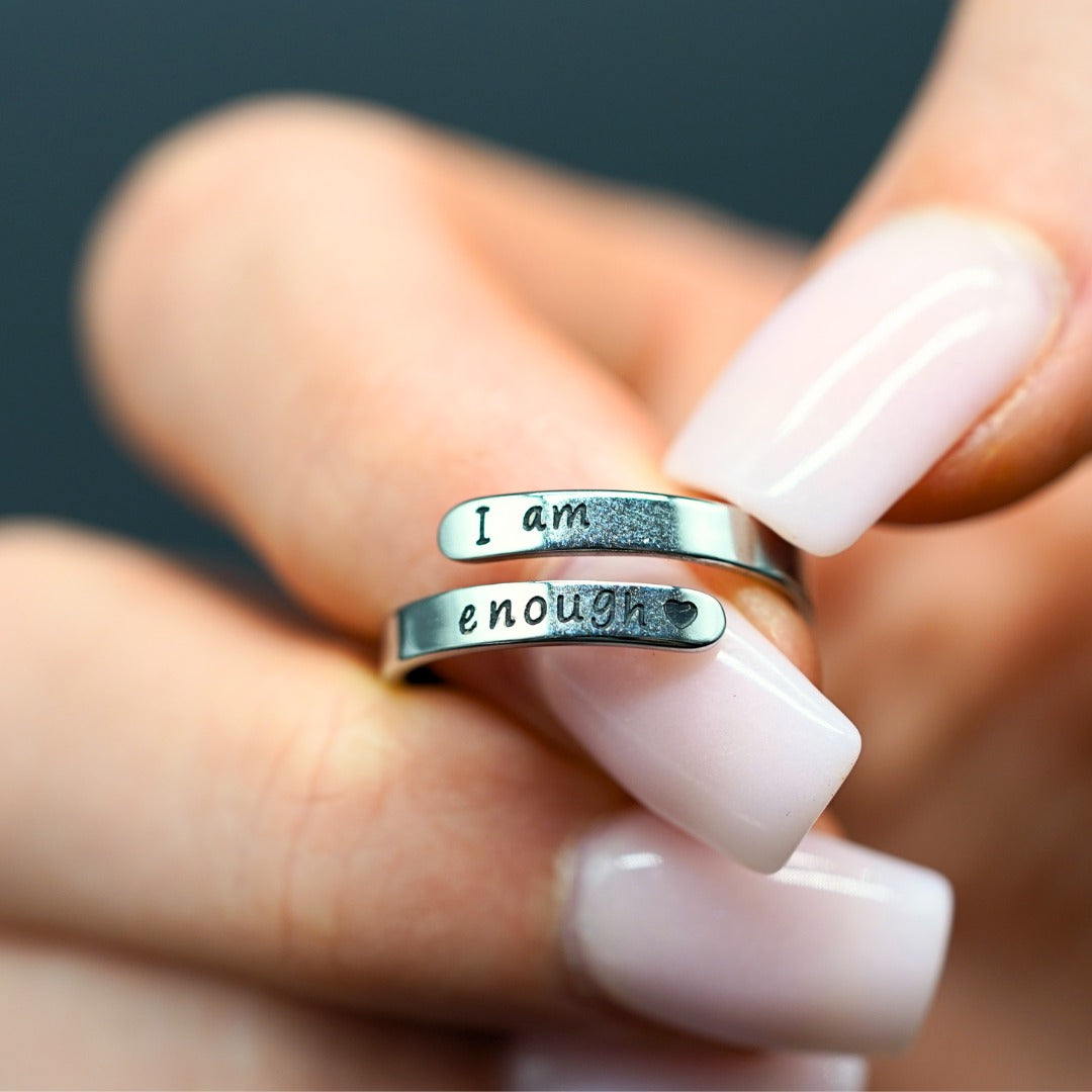 I Am Enough ring held between fingers